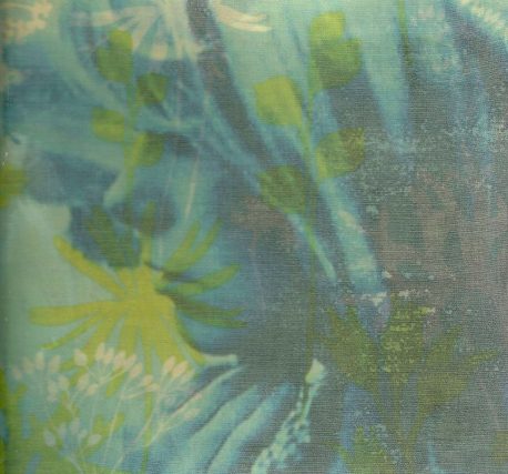 Picture of a woman covered by fabric of blue and green flowers